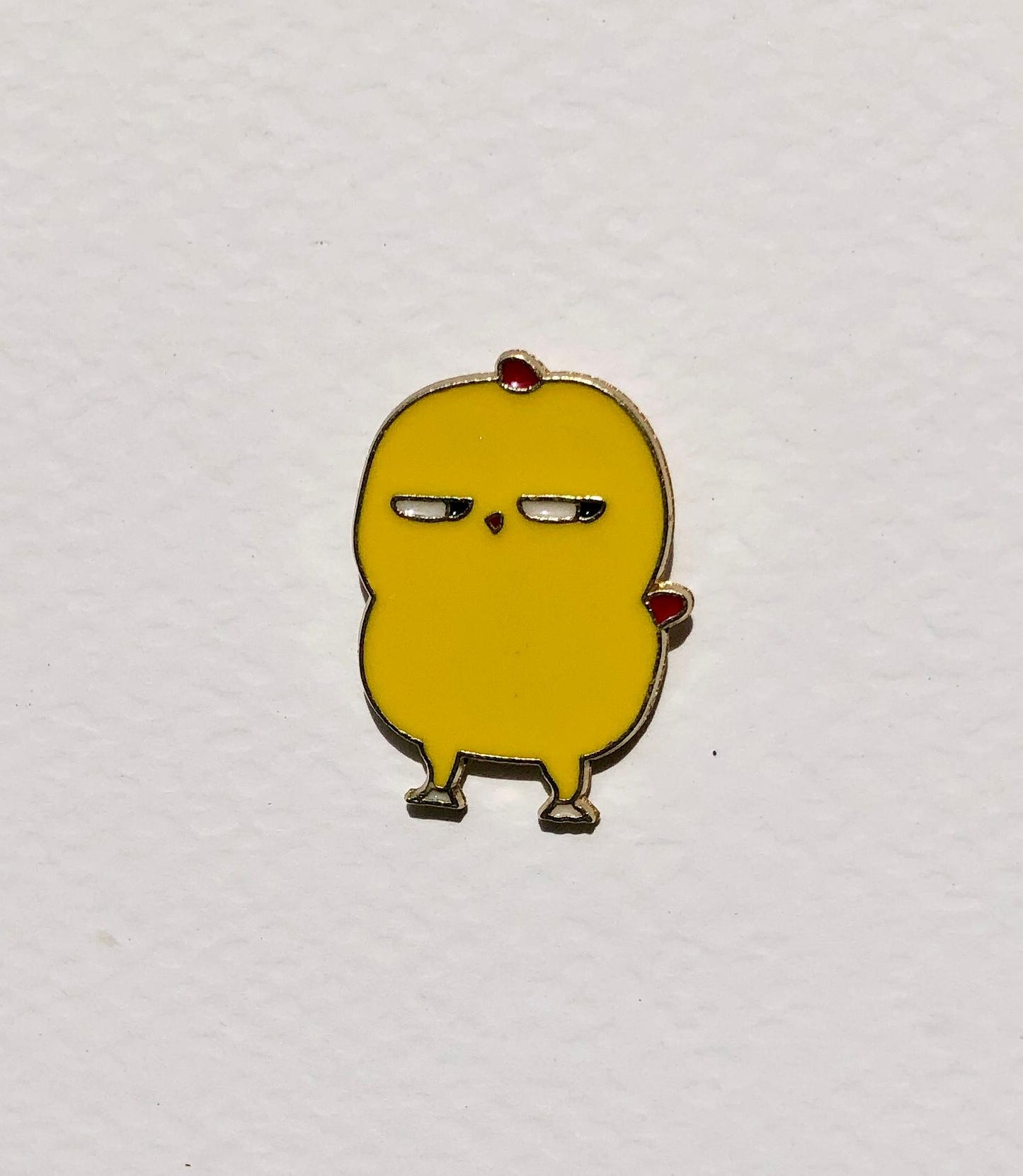 Yellow cartoon-like character with red shoes on a white background