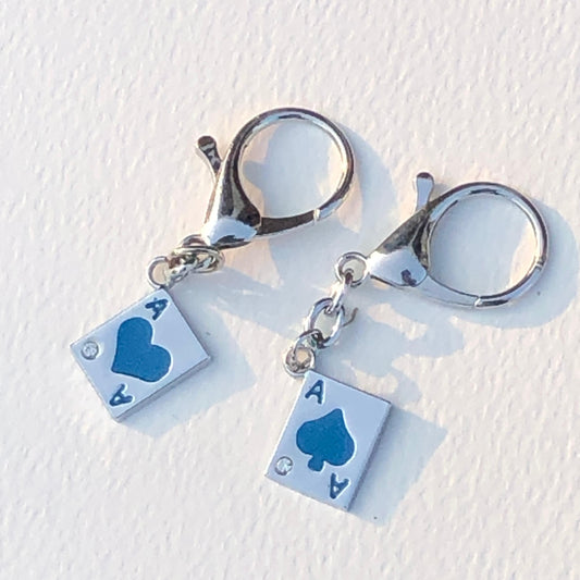 Keychain with playing card suit charms on a white background