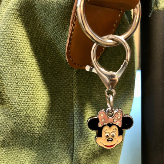 Keychain with a cartoon character charm attached to a leather strap.