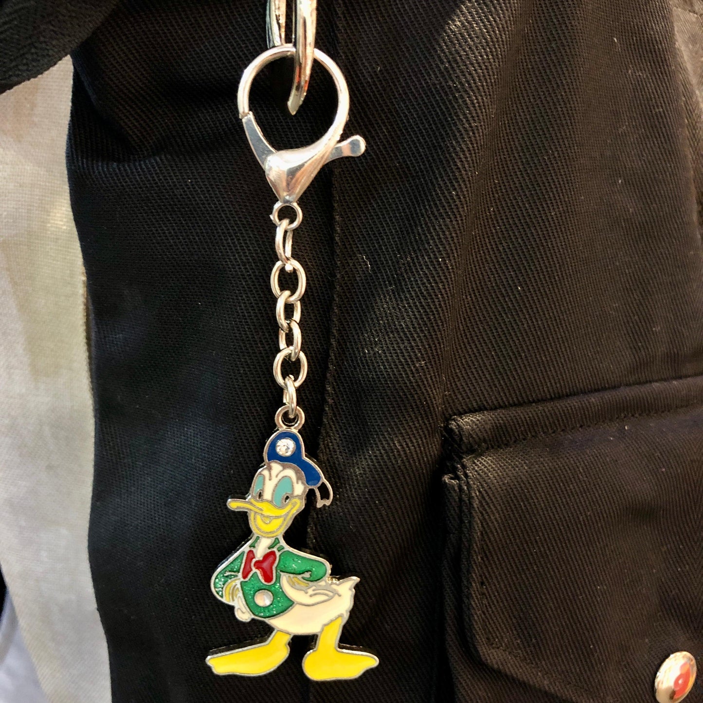 Keychain with cartoon character attached to a black bag