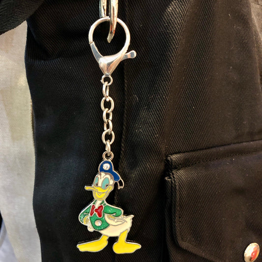 Keychain with cartoon character attached to a black bag
