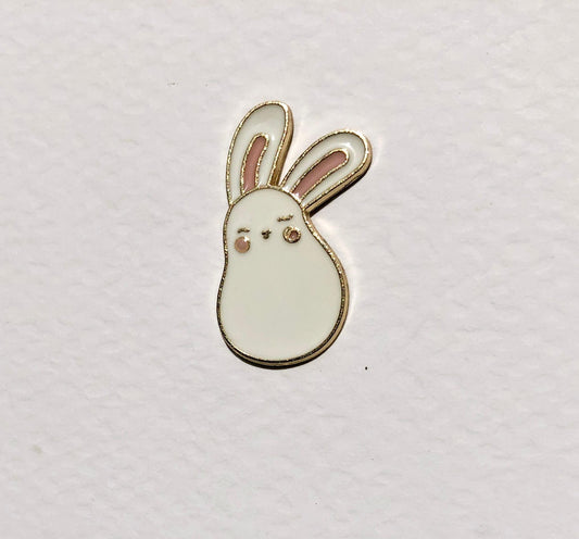 Small white bunny-shaped object on a light gray background