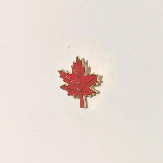 Red maple leaf emblem on a white background