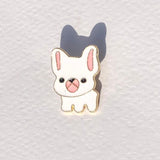 Cute cartoon dog pin on a textured white background